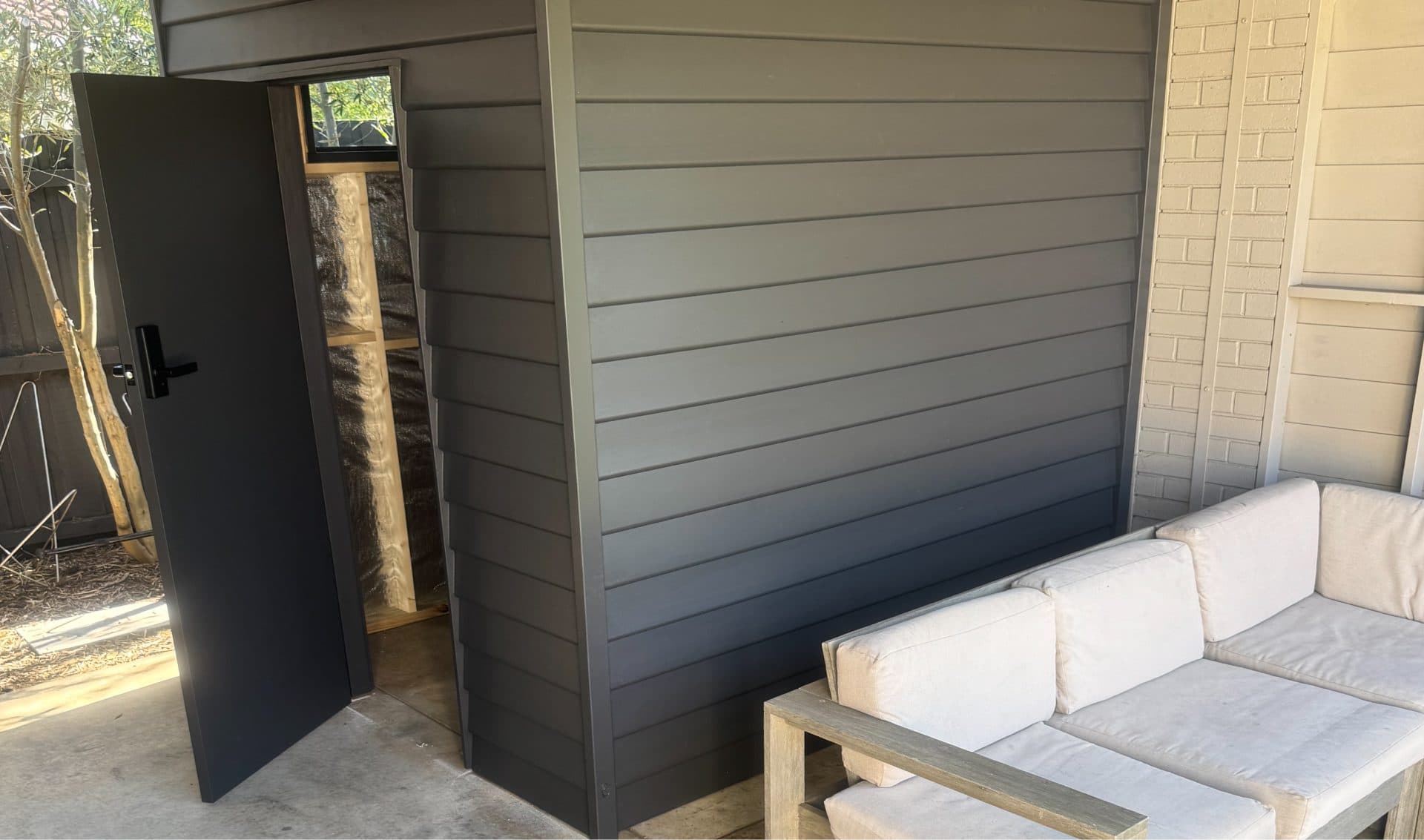 New cladding and door on a finished outdoor room
