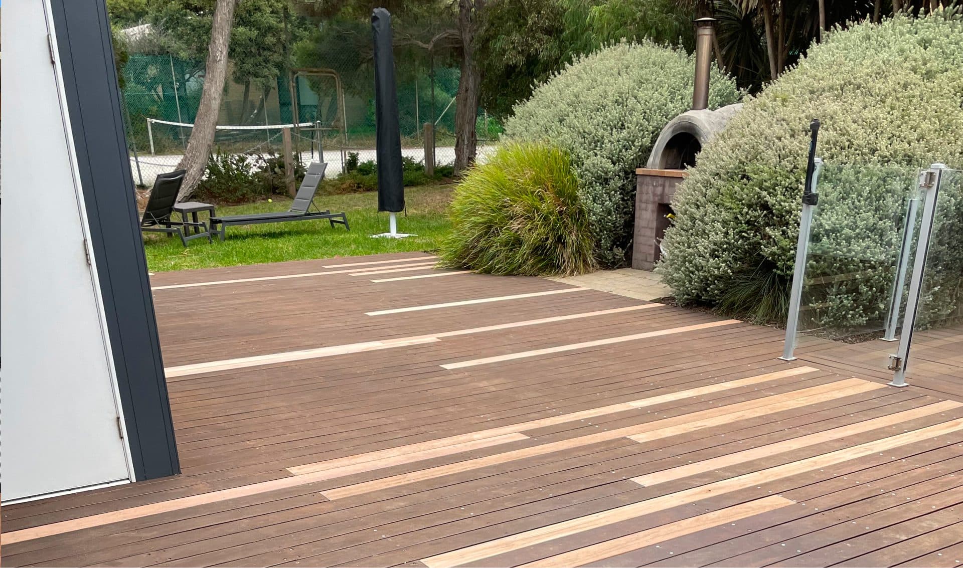 Freshly laid timber decking beside a landscaped garden